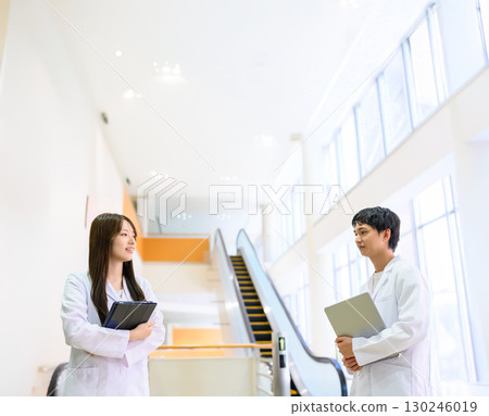 Men and women in white coats 130246019