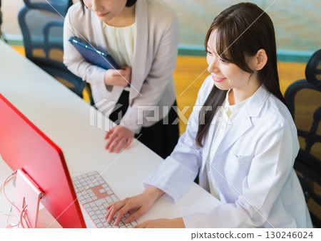 A woman in a white coat and a woman in a jacket 130246024