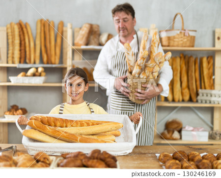 Father and little daughter - selling bread and various baguettes for sale Father and little daughter - selling bread and various baguettes for sale 130246169