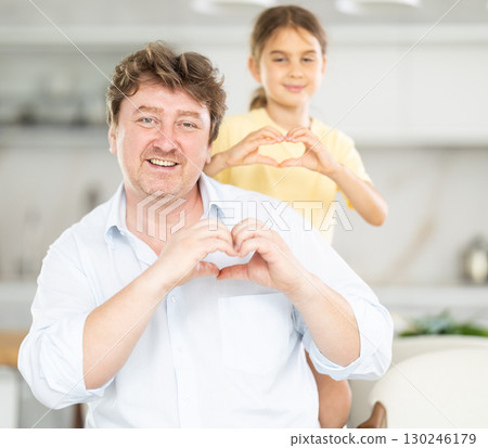 Father and daughter posing in kitchen at home Father and daughter posing in kitchen at home 130246179