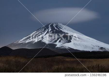 A breathtaking and fantastical night view of Mount Fuji and its cap clouds 130246196