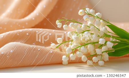 A bouquet of lily of the valley on a tablecloth 130246347