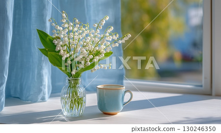 Lily of the valley flowers on a table by the window 130246350