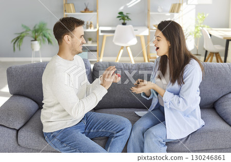 Man Proposing To Woman With Ring At Home Man Proposing To Woman With Ring At Home 130246861