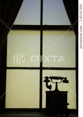 Silhouette of a phone by the window 130247393