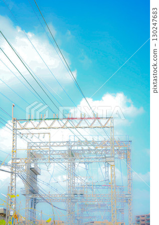 A nostalgic summer memory. A steel tower soaring against the blue sky and a nostalgic landscape. A nostalgic summer memory. A steel tower soaring against the blue sky and a nostalgic landscape. 130247683