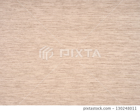 Softly woven hues of ocean sand on a textured oak veneer surface 130248011
