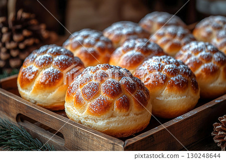 Bakehouse. Christmas buns in the shape of a pine cone in on a wooden trading tray on a white background. 130248644
