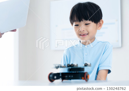 Boy playing with robot 130248762