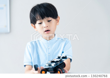 Boy playing with robot 130248768