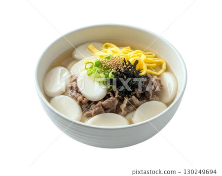 Traditional Korean Rice Cake Soup with Beef and Egg Garnish in White Bowl Traditional Korean Rice Cake Soup with Beef and Egg Garnish in White Bowl 130249694