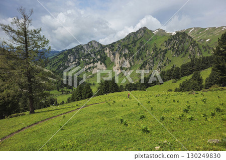 tourist walking down a slope in the distance 130249830