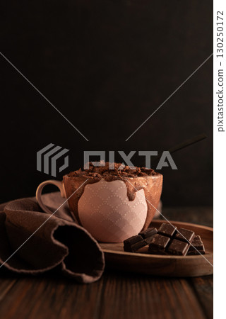Chocolate mug cake on dark wooden table.Easy homemade dessert. Mugcake from microwave 130250172