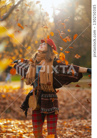 happy young woman in red hat with scarf and gloves rejoicing happy young woman in red hat with scarf and gloves rejoicing 130250385