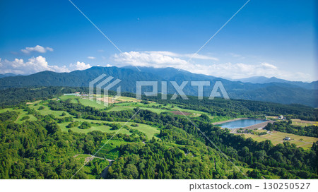 A view of ranches, reservoirs, Toyama Bay, and rice paddies from the hills of Kurobe City in eastern Toyama Prefecture, Japan 130250527