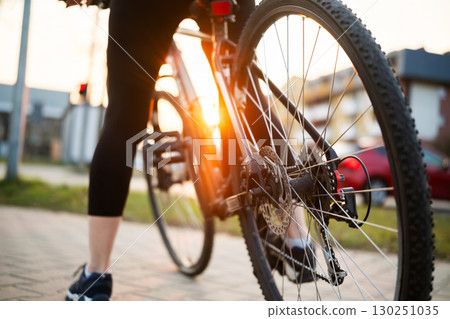 Girl Legs With Mountain Bike And Gear Mechanism Close Up In Park 130251035