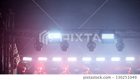Celling Spotlights Illuminate The Concert Stage During A Light Show 130251049