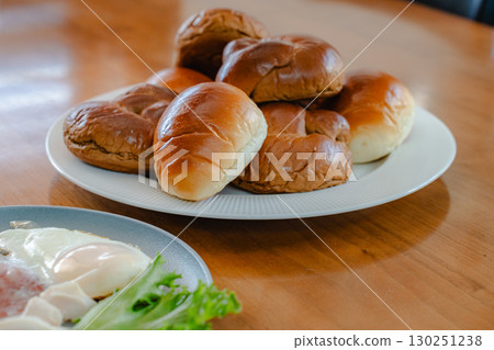 Breakfast consisting of rolls and Japanese and Western side dishes Breakfast consisting of rolls and Japanese and Western side dishes 130251238