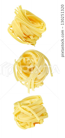 set of falling soaring flying nests of raw tagliatelle, isolated on white background set of falling soaring flying nests of raw tagliatelle, isolated on white background 130251320