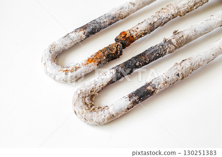 old broken burnt-out electric heating element 130251383