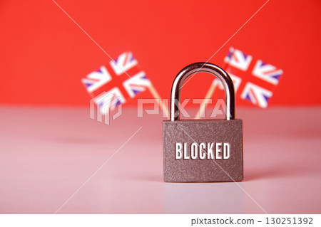 Closed padlock with the inscription lock on background of the flag of Britain. 130251392