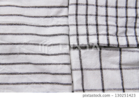 Plaid material. Towel on the table. Wrinkled fabric with stripes. 130251423