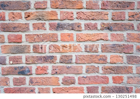 Brown structural stone wall of the ancient building consists of bricks. Nature structural background. 130251498