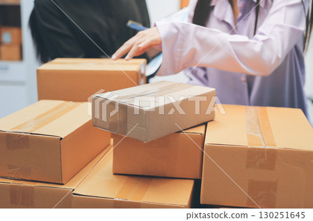 Portrait of Starting small businesses SME owners, two Asian woman check online orders Selling products working with boxs freelance work at home office, sme business online small medium enterprise Portrait of Starting small businesses SME owners, two Asian woman check online orders Selling products working with boxs freelance work at home office, sme business online small medium enterprise 130251645