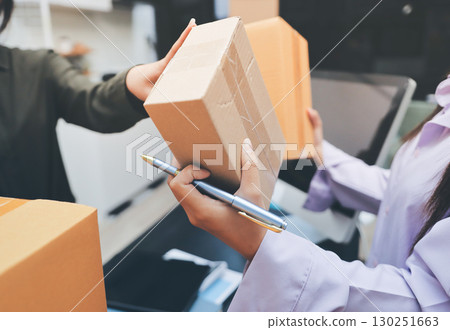 Portrait of Starting small businesses SME owners, two Asian woman check online orders Selling products working with boxs freelance work at home office, sme business online small medium enterprise 130251663