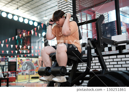 Plus-size man training his core muscles. Strength and determination. Plus-size man training his core muscles. Strength and determination. 130251861