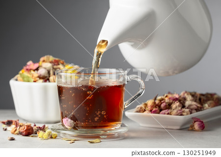 Herbal tea is poured into a glass mug. Herbal tea is poured into a glass mug. 130251949