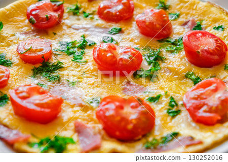 omelet with cherry tomatoes, close-up, selective focus 130252016