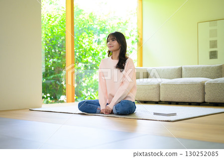 A woman relaxing in the living room A woman relaxing in the living room 130252085