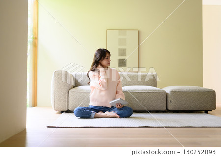 A woman relaxing in the living room 130252093