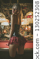 Korean model in stylish outfit poses in unique bar setting at night with warm lighting and detailed background 130252308