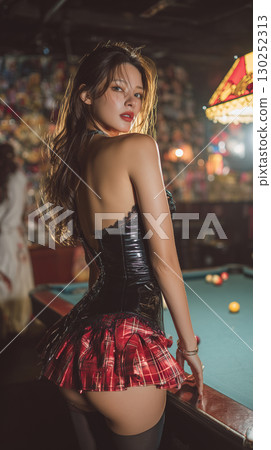 Model poses confidently in a bar setting wearing a stylish outfit with plaid details and a corset during an evening event 130252313