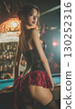 Model posing in a vintage bar with intricate decor in a dramatic evening setting 130252316