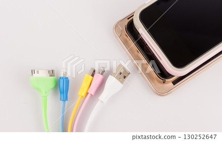 Various USB cables with phone on white background Various USB cables with phone on white background 130252647