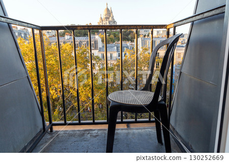 Small balcony with one chair and a view of the city. Paris, France 130252669