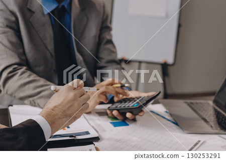 Accounting company provide finance and taxation planning for profitable cash flow, Auditor and accountant team working in office, analyze financial data and accounting record with calculator.Insight Accounting company provide finance and taxation planning for profitable cash flow, Auditor and accountant team working in office, analyze financial data and accounting record with calculator.Insight 130253291