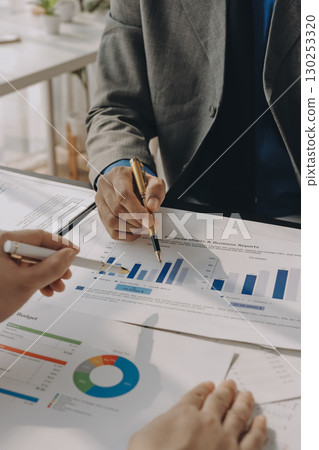 Accounting company provide finance and taxation planning for profitable cash flow, Auditor and accountant team working in office, analyze financial data and accounting record with calculator.Insight 130253320