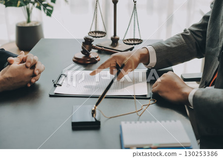 Lawyer explained to the client about the law that must be brought against the court case. 130253386