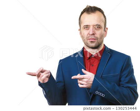 Elegant man in suit pointing on copy space Elegant man in suit pointing on copy space 130253444