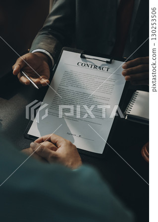 Lawyer explained to the client about the law that must be brought against the court case. Lawyer explained to the client about the law that must be brought against the court case. 130253506
