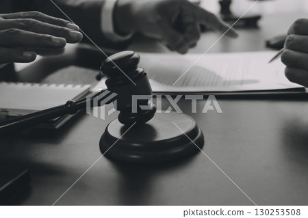 Lawyer explained to the client about the law that must be brought against the court case. Lawyer explained to the client about the law that must be brought against the court case. 130253508