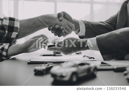 Car salesman gave the keys to the customers who signed the purchase contract legally, Successful completion of car sales, Purchase contract and key delivery. 130253548