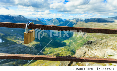 Padlock on rail and mountains view, Norway Padlock on rail and mountains view, Norway 130253624