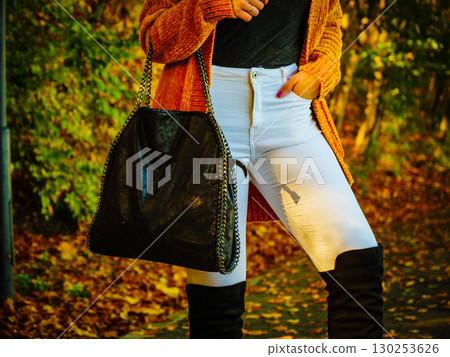Woman wearing orange autumn cardigan outdoor 130253626