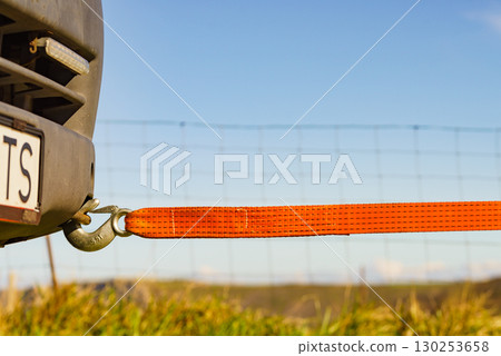 Tow hook with orange strap on car. Towing equipment. 130253658
