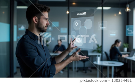 Professional Man Interacting with Virtual Interface of AI Agents in Modern Office 130254491
